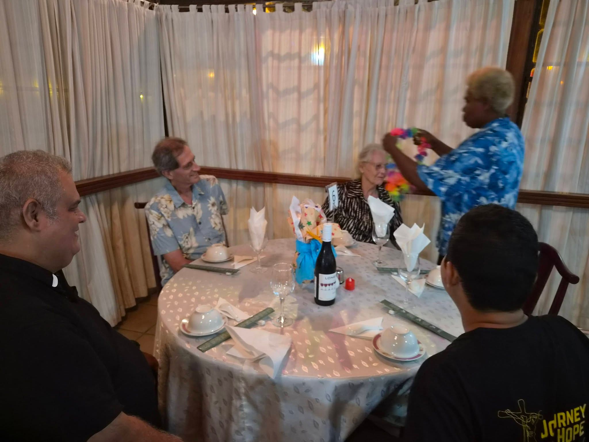 Group dining experience with guests at a round table in the restaurant.