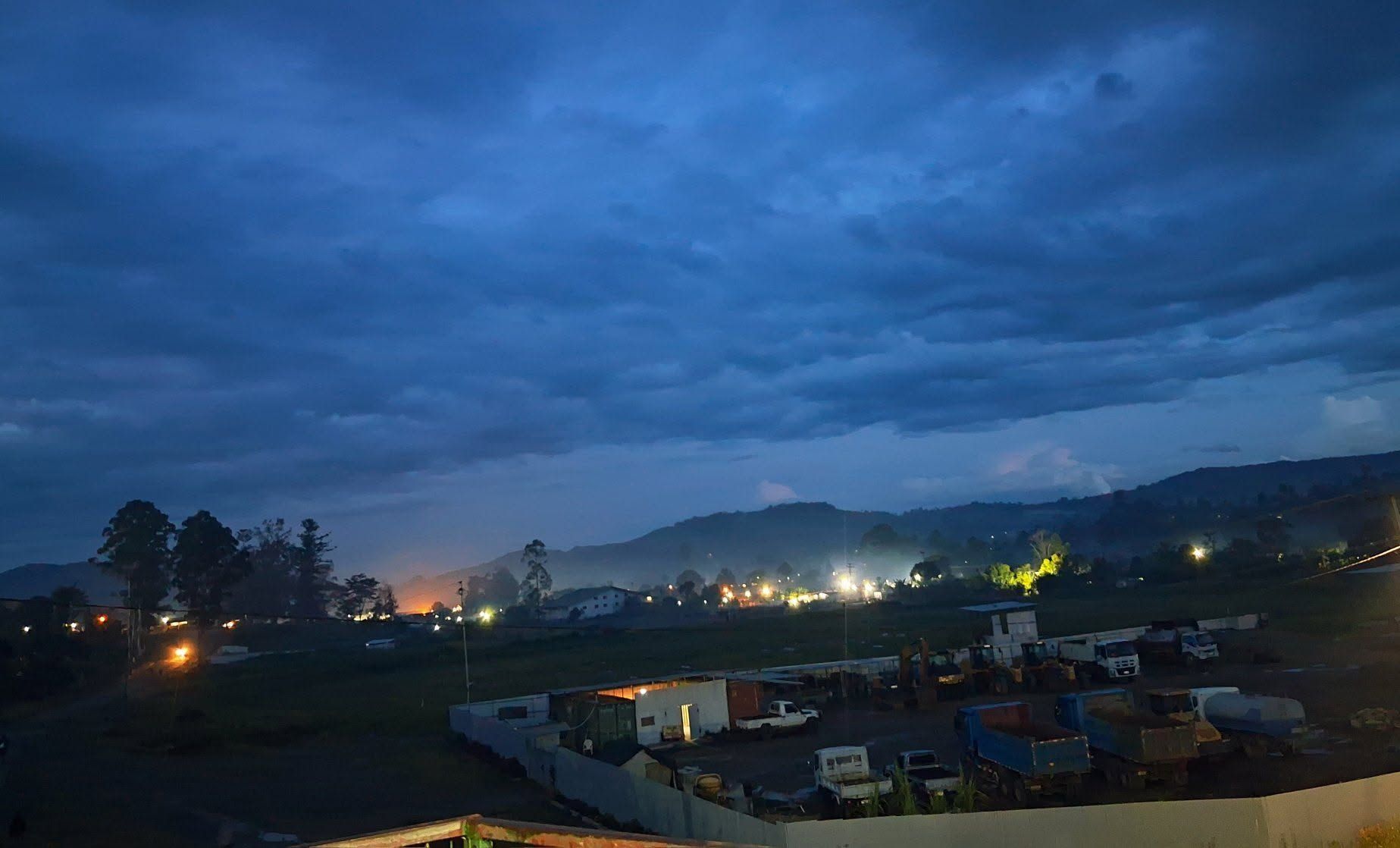 Twilight view of the surrounding mountain ranges and valley lights.