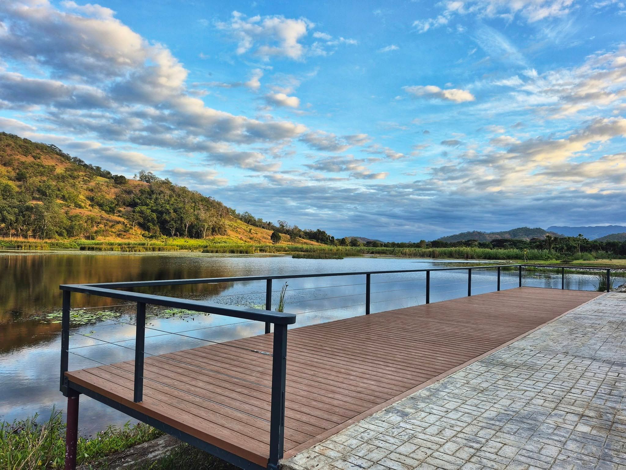 Wooden observation deck extending over the lake with scenic mountain views.