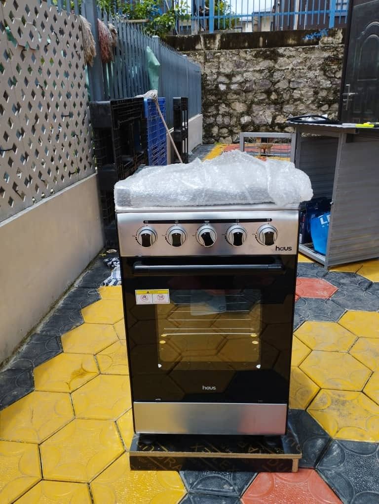 Close-up of a new four-burner gas oven stove being installed on the property patio.