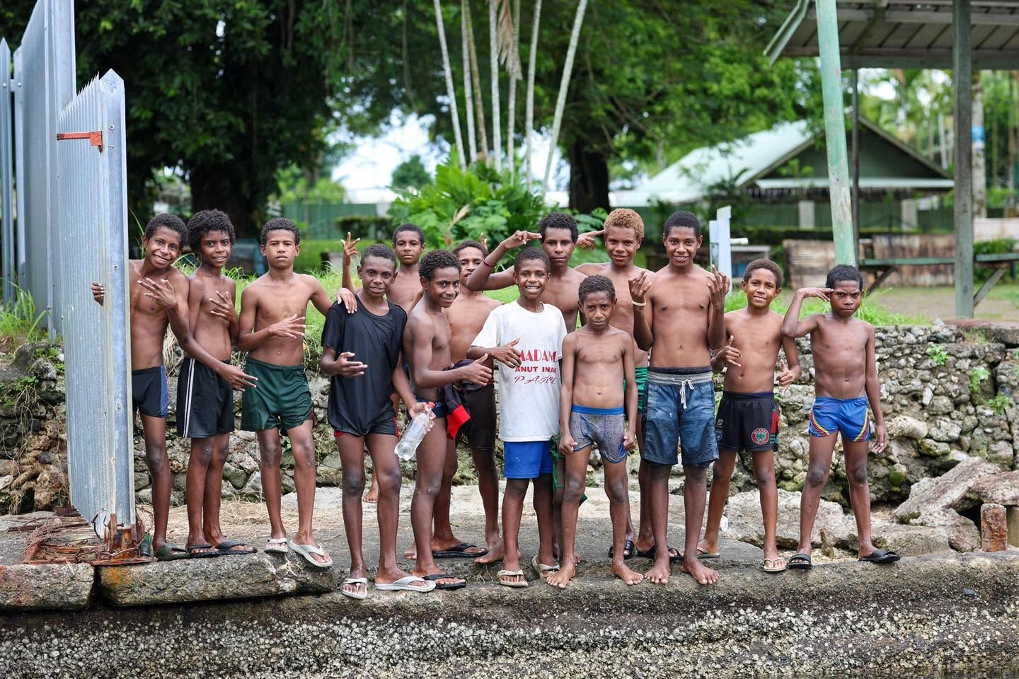 Local residents posing by a sea wall near the resort