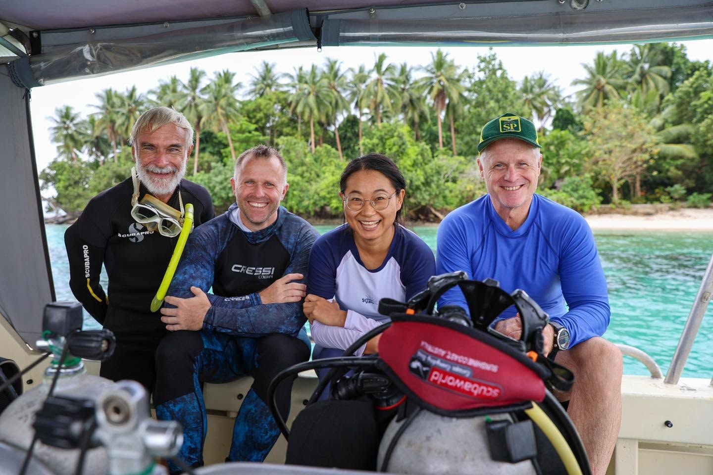 Group of scuba divers smiling on board a dive boat