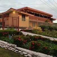Daytime view of the property with a landscaped garden.
