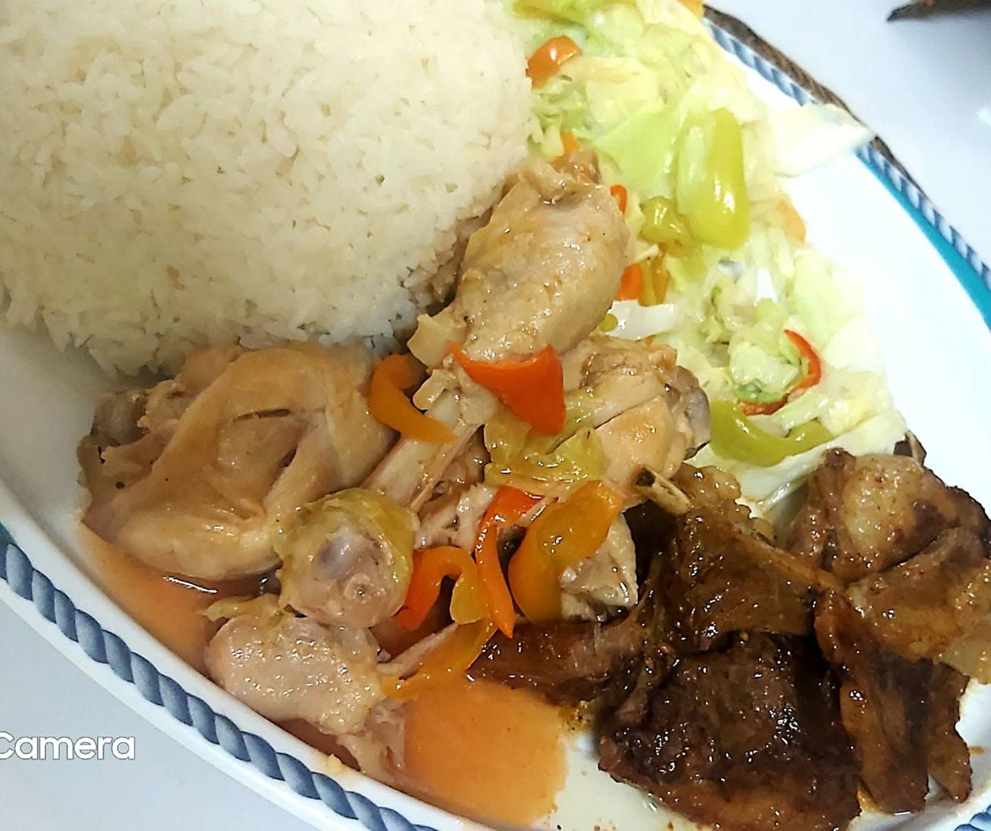 Hot meal serving with rice, chicken, and vegetables.