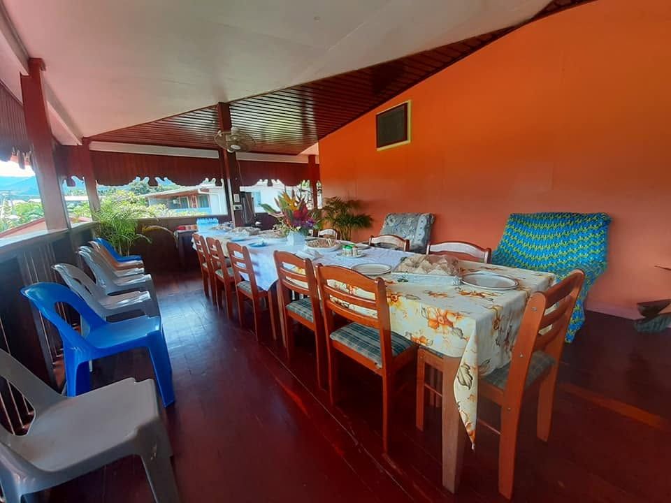 Long dining table set for guests on the veranda.