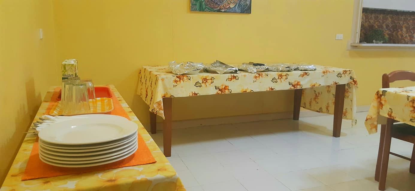 Buffet serving area with stacked plates and flatware.