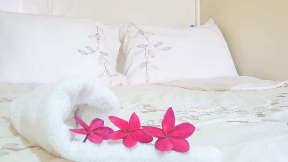Close-up of fresh linens decorated with tropical flowers.