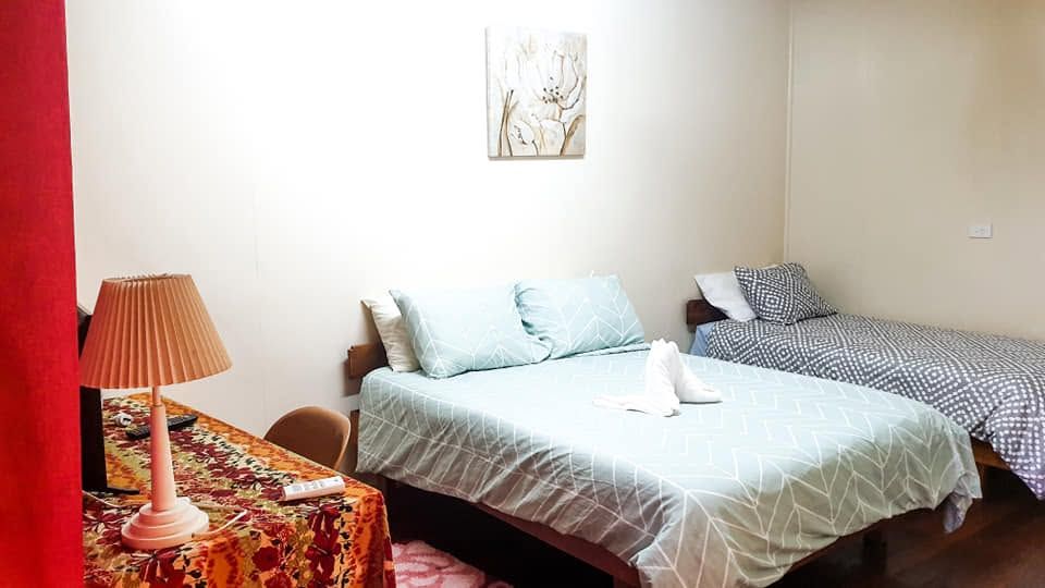 Guest room featuring a double bed and a single bed.
