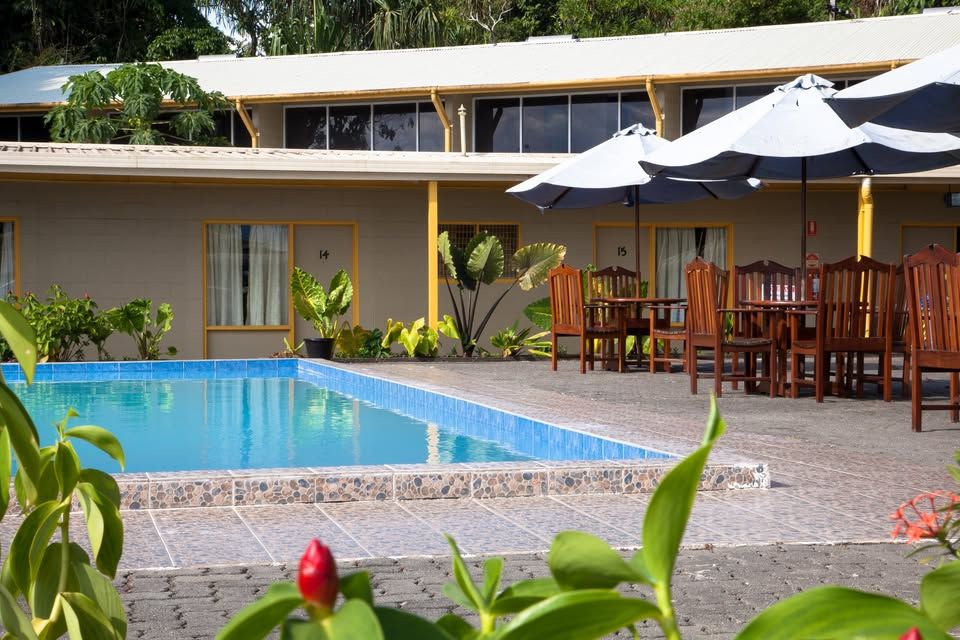 Outdoor swimming pool with patio seating and parasols
