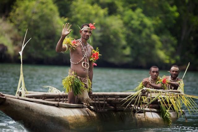 Guests enjoying a traditional outrigger canoe experience in the fjord.
