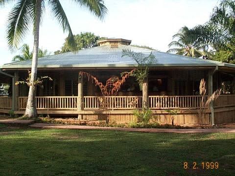 The main lodge building with a large wooden wrap-around veranda.