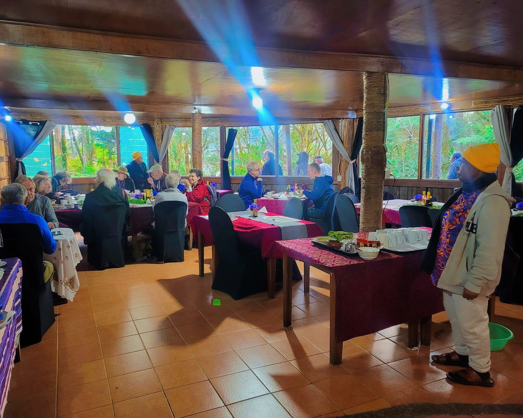 Large group of diners seated at tables in the lodge restaurant.